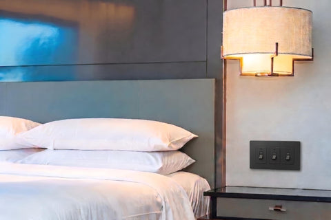 Black designer light switch cover in a modern bedroom